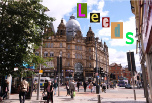 Leeds town centre with the word Leeds spelled out in bright coloured letters